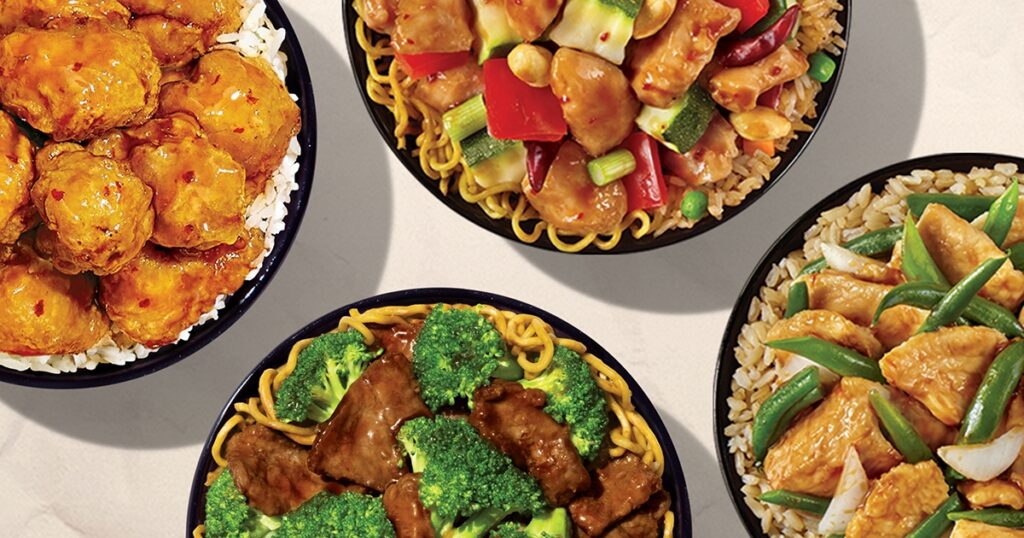Four bowls of food are shown from above, each holding delicious dishes like broccoli beef, chicken with green beans, breaded chicken, and a veggie stir-fry—all looking fresh and flavorful with no excess oil, as if made straight from a clean grease trap.